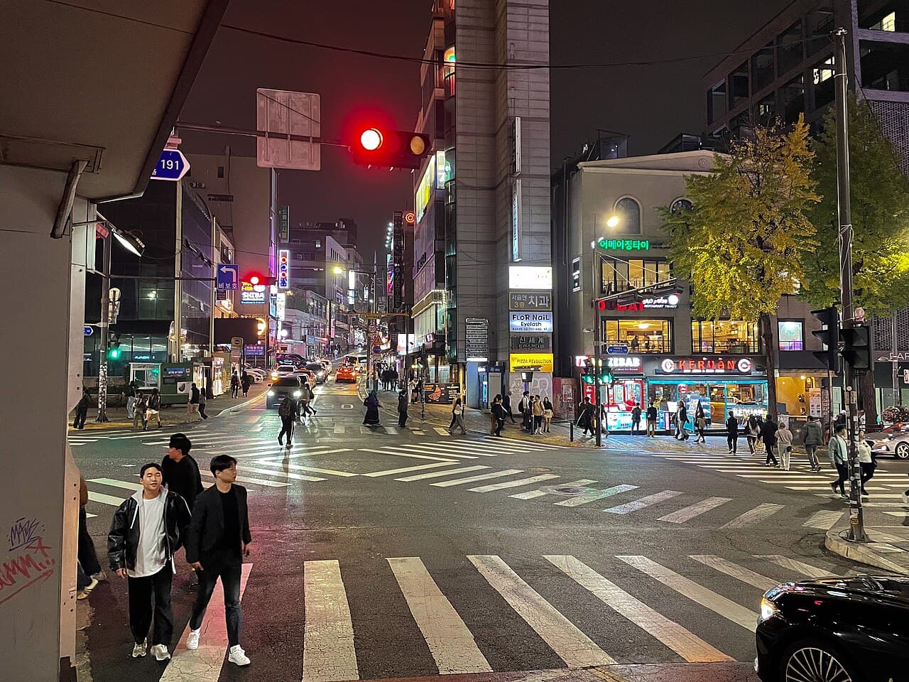 A pedestrian crossing in Itaewon, Seoul, at night — the district that anchors Seoul's house and techno scene