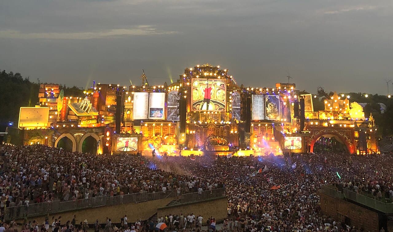 The crowd and lit-up mainstage at Tomorrowland — the kind of major festival stage hard techno broke into during the 2020s