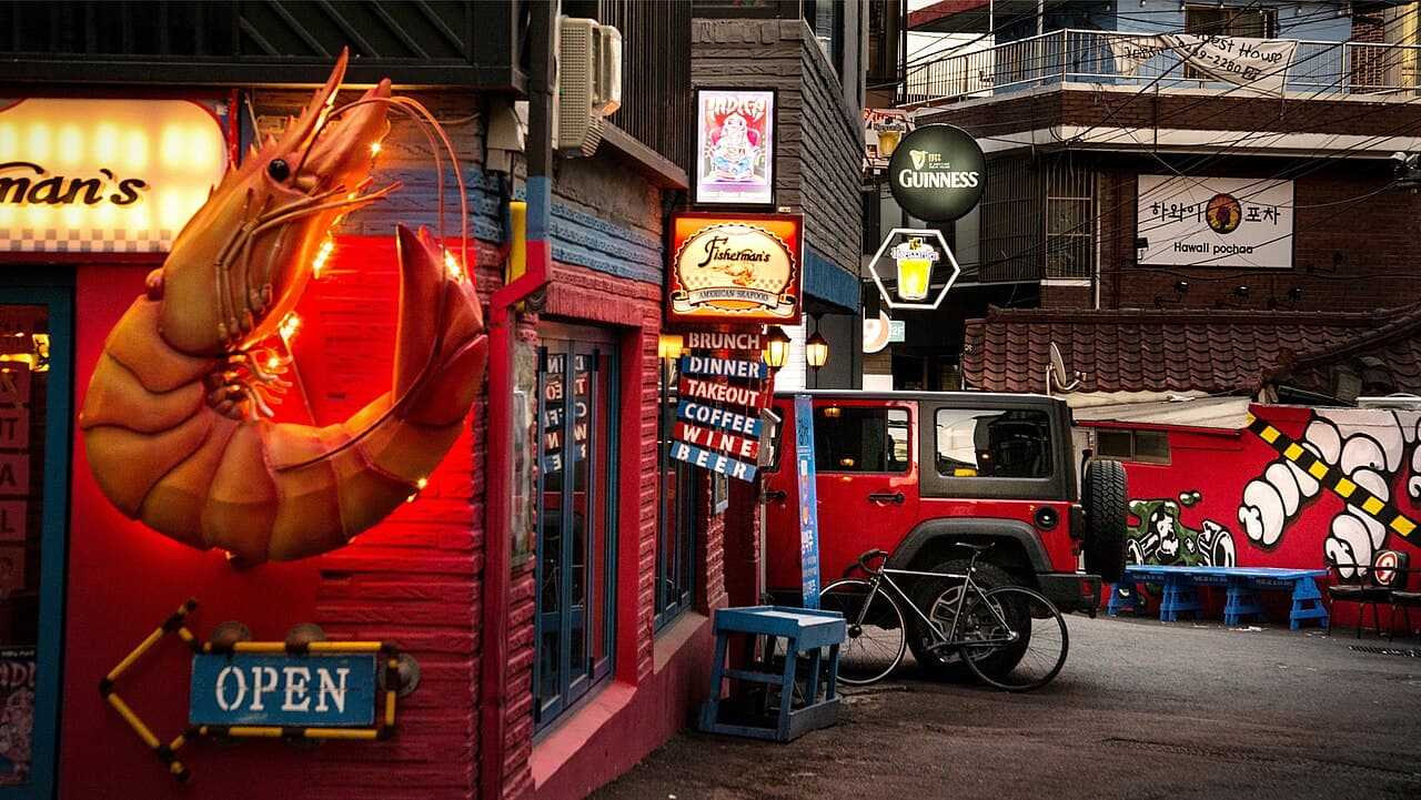 A night alley in Itaewon, Seoul — the district where Volnost's two-floor room is located